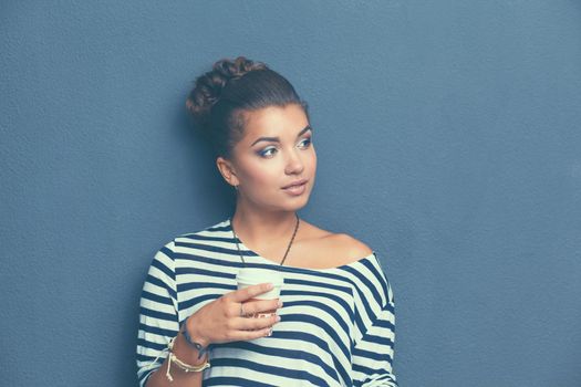 Portrait of young woman with cup tea or coffee.