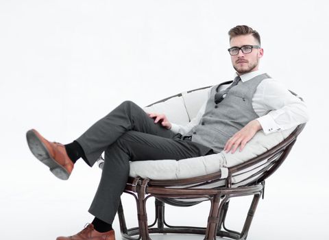 side view.modern successful man sitting in a round chair.photo with copy space