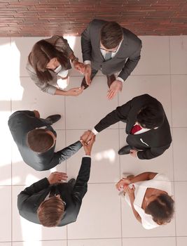 top view.business partners shaking hands.business concept