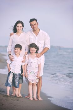 happy young family have fun and live healthy lifestyle on beach