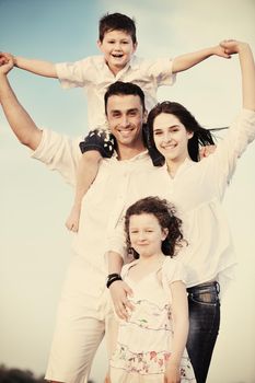 happy young family have fun and live healthy lifestyle on beach