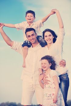 happy young family have fun and live healthy lifestyle on beach