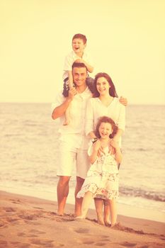 happy young family have fun and live healthy lifestyle on beach