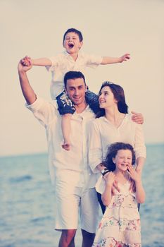 happy young family have fun and live healthy lifestyle on beach