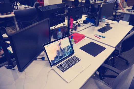 dual monitor screen and laptop computer at modern office indoors, startup company software develop  technology