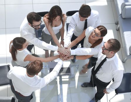 top view.employees of the company making a tower out of hands.the concept of teamwork