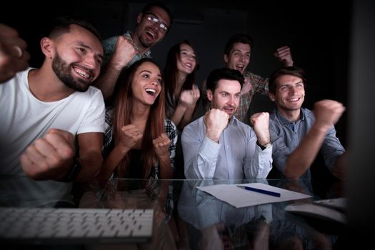 happy business team looking at computer monitor. the concept of overtime