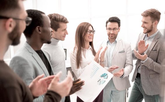 close up.business team applauding while standing in the office. concept of success