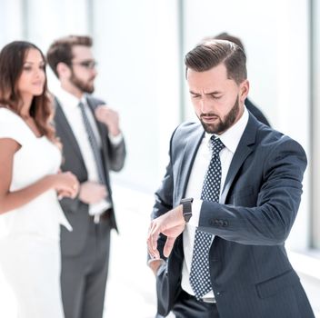 confident businessman looking at his wristwatch.business concept