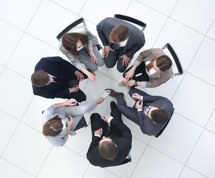 top view.a group of employees sitting in a circle.the concept of teamwork