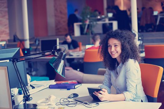 happy young  business woman with curly hairstyle in the modern office