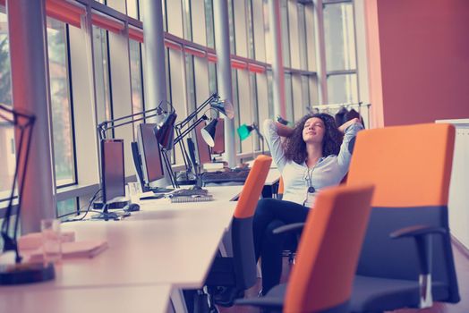 happy young  business woman with curly hairstyle in the modern office