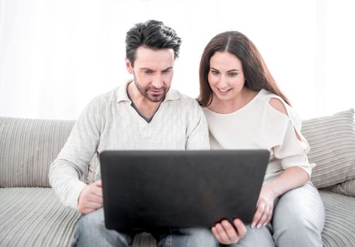 laughing couple looking at the laptop screen.photo with copy space