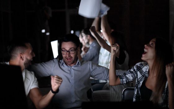 triumphant employees at the Desk.the concept of teamwork