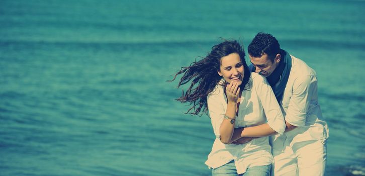 happy young couple in white clothing  have romantic recreation and   fun at beautiful beach on  vacations