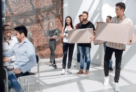 creative business team brings cardboard boxes to the new office.the concept of a startup