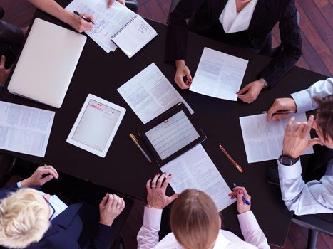 top view of  business people group on meeting, working in modern bright office indoor with tablet computer