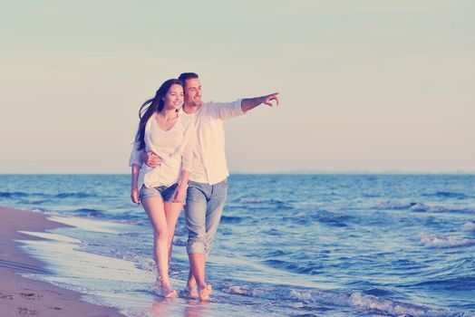 happy young romantic couple in love have fun on beautiful beach at beautiful summer day