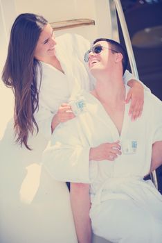 Romantic young couple spending time together and relaxing on yacht