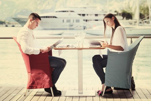 happy young couple having lanch at beautiful restaurant on by the sea on  beach