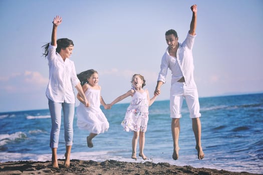 happy young family in white clothing have fun at vacations on beautiful beach 