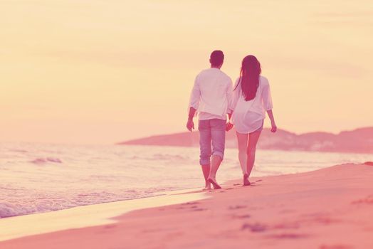 happy young romantic couple in love have fun on beautiful beach at beautiful summer day