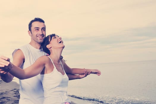 happy young couple in white clothing  have romantic recreation and   fun at beautiful beach on  vacations