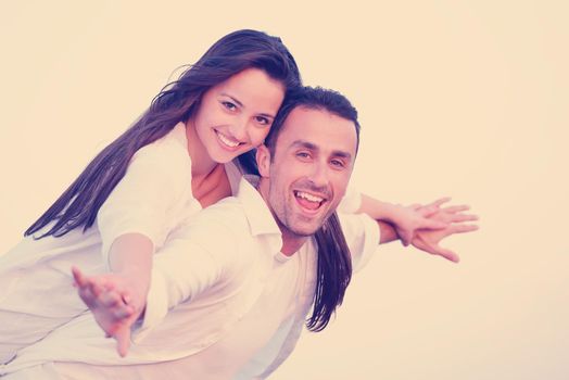 happy young romantic couple in love have fun on beautiful beach at beautiful summer day