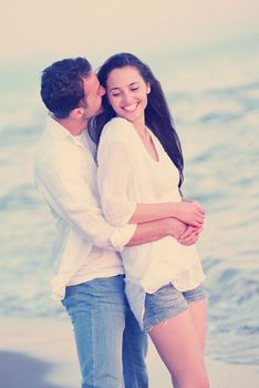 happy young romantic couple in love have fun on beautiful beach at beautiful summer day