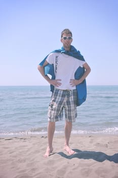 funny superhero standin at beach on hot sand