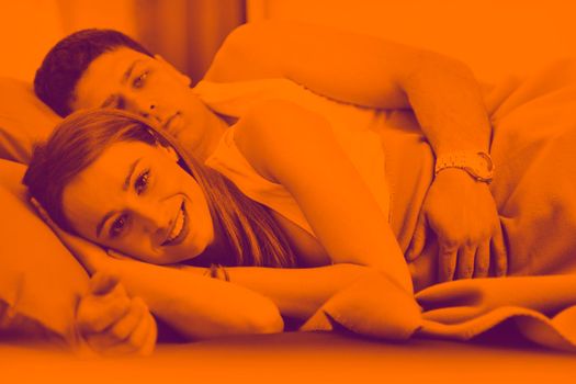 happy young couple in bed at morning duo tone