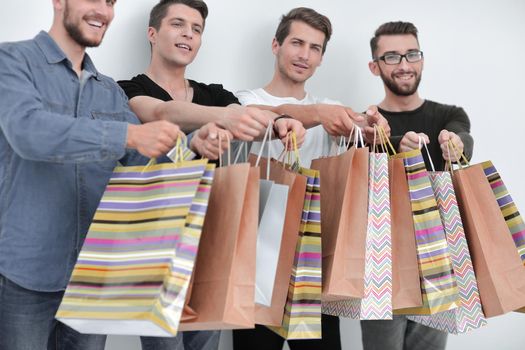 paper bags in the hands of a team of friends.the concept of shopping