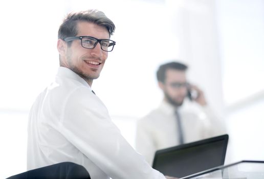 rear view.employees sitting at the office Desk.business background.