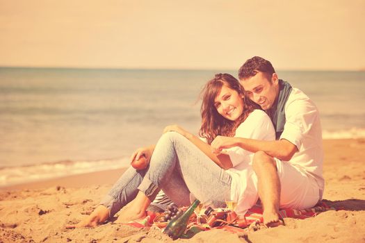 happy young couple enjoying  picnic on the beach and have good time on summer vacations