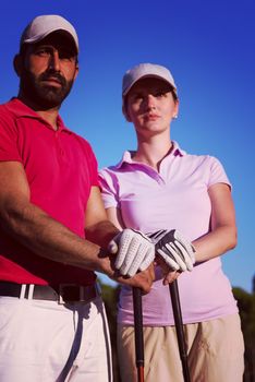 portrait of happy young  couple on golf course