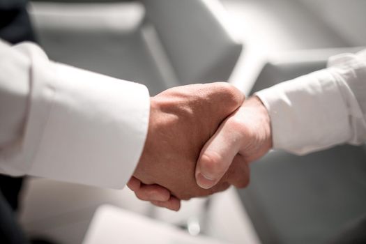 close up.reliable handshake of business partners .the concept of cooperation