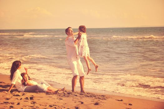 happy young family in white clothing have fun at vacations on beautiful beach 