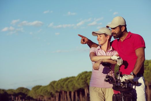 portrait of happy young  couple on golf course