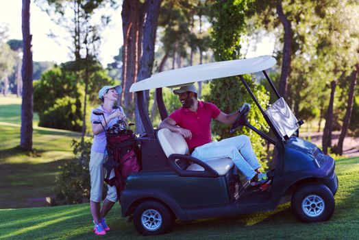 couple in buggy cart on golf course