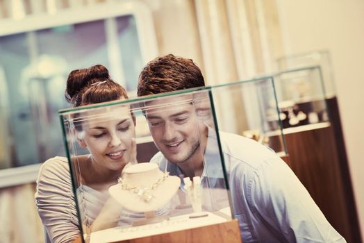 happy young romantic couple in love buy jewelry ring in luxury store