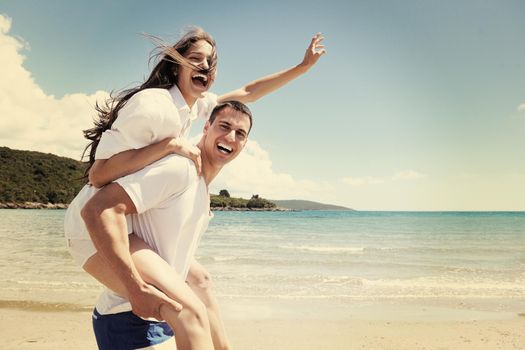 happy young couple have fun and relax  on the beach