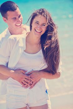 happy young couple have fun and relax  on the beach