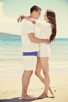 happy young couple have fun and relax  on the beach