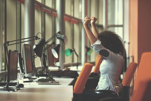 happy young  business woman with curly hairstyle in the modern office