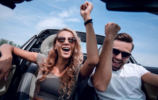 close up.a happy couple travelling in a convertible.the freedom of the open road