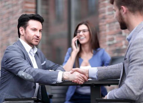 meeting business colleagues at a table on the street .meetings and partnerships