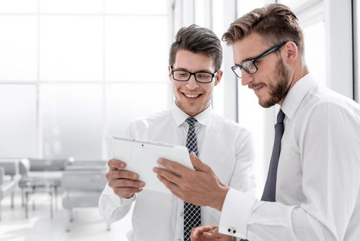 close up.employees read the message on a digital tablet.photo with copy space