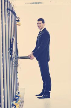 young handsome business man  engeneer in datacenter server room 