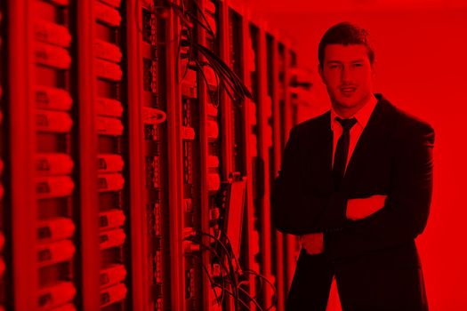 young handsome business man  engeneer in datacenter server room 