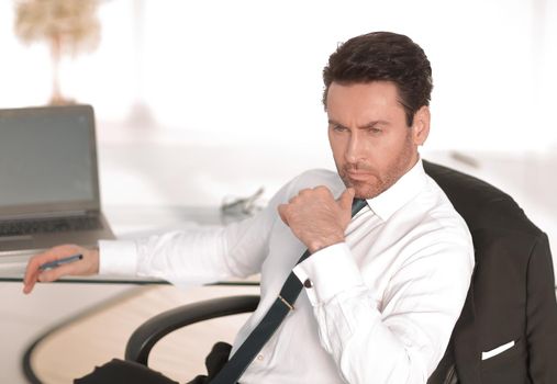 close up.thoughtful businessman sitting at his Desk.photo with copy space